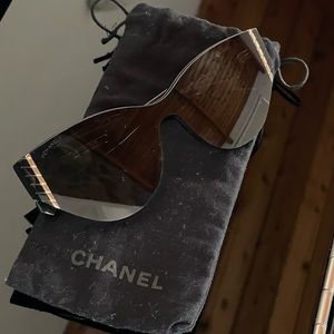 CHANEL Sunglasses. All black, with gold details.